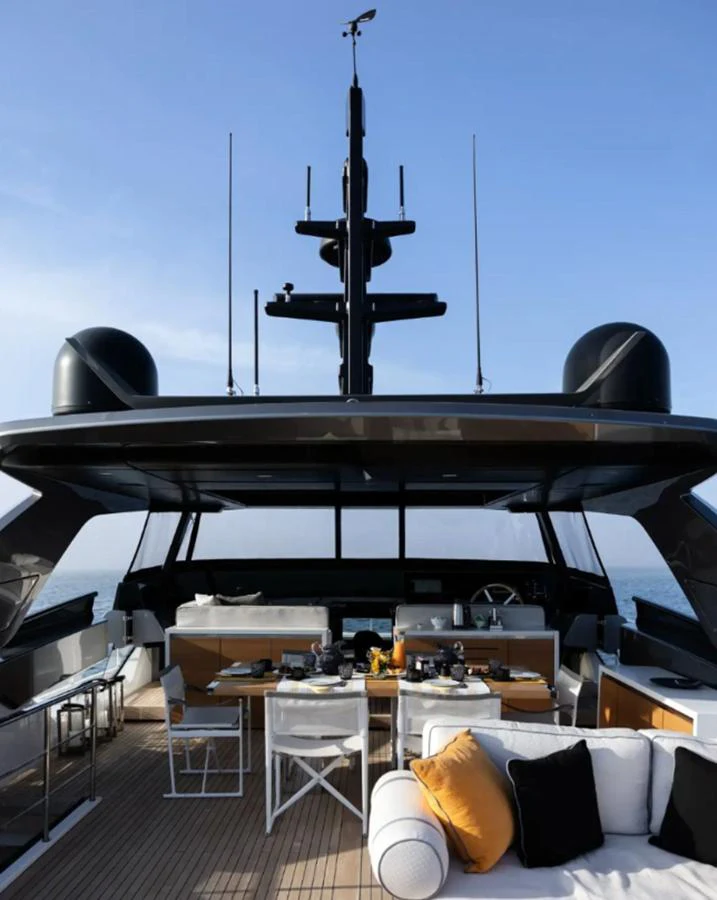 The aft deck features a stylish outdoor dining area with comfortable seating and a modern design. aboard SOLEDO Yacht for Sale