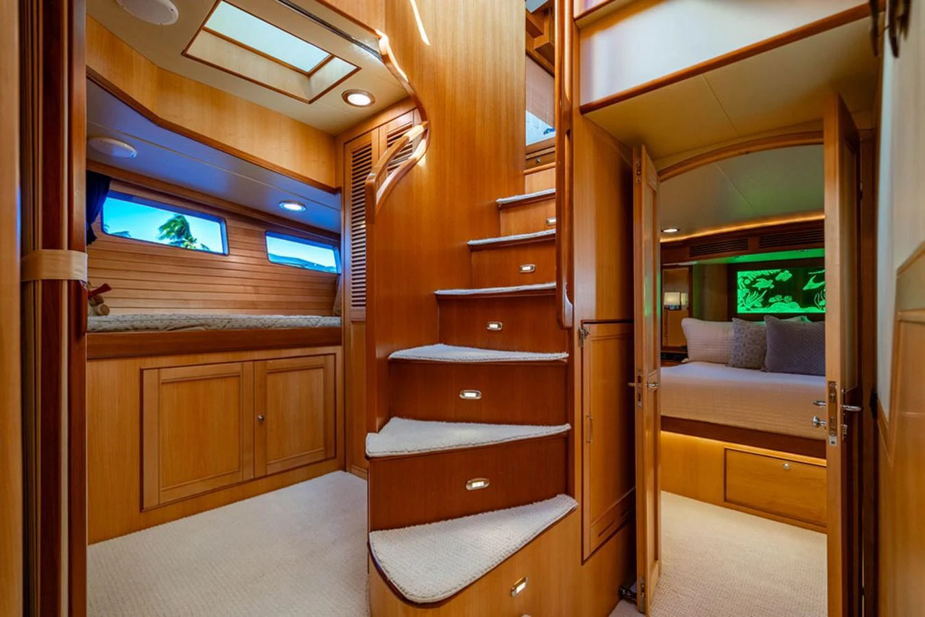 a room with a wood door and a tv on the wall aboard NEVER BETTER Yacht for Sale