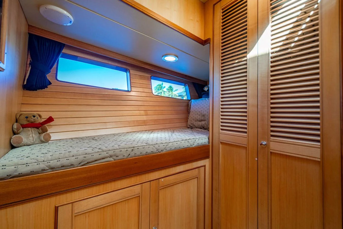 a stuffed toy on a bed aboard NEVER BETTER Yacht for Sale