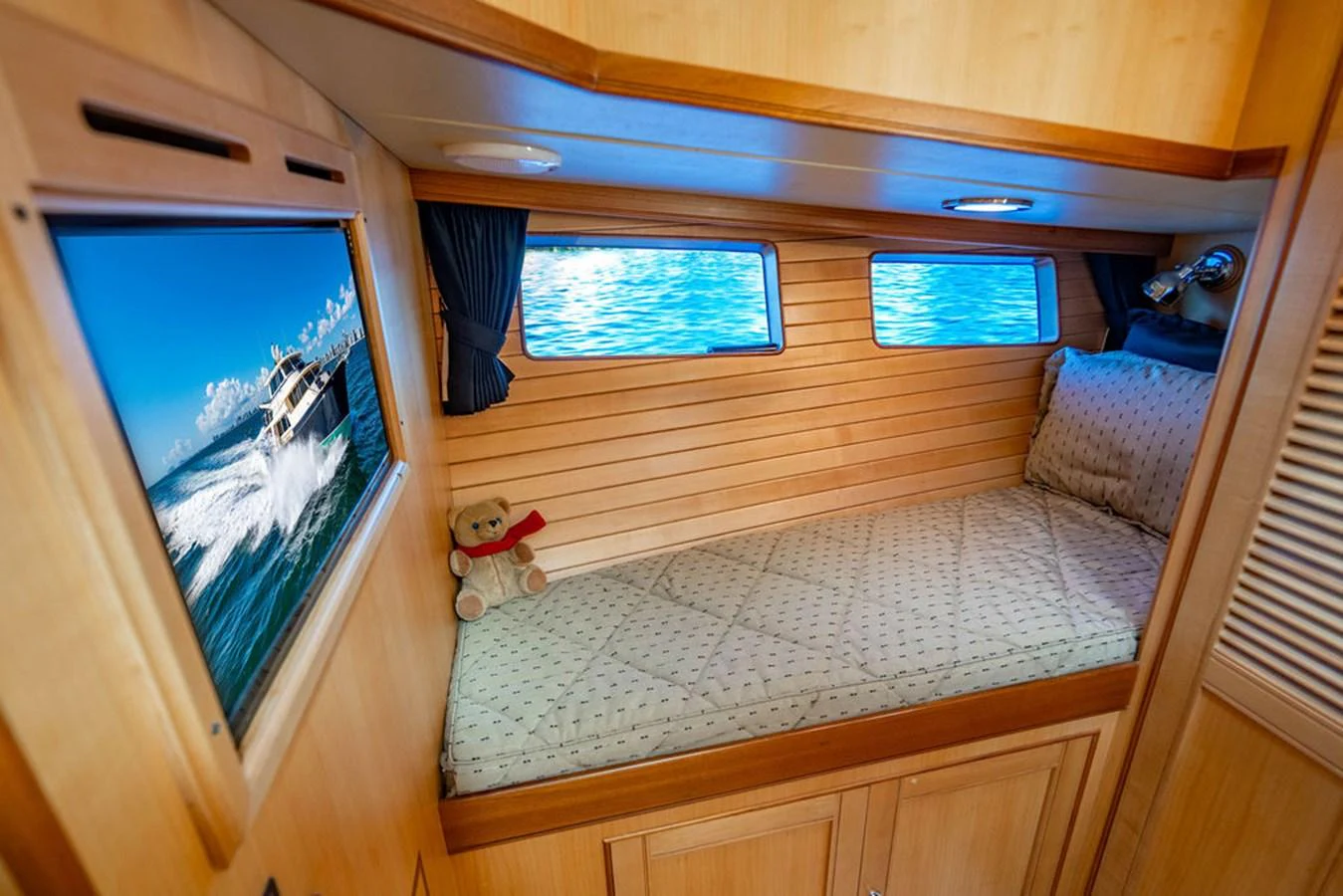 a room with a bed and a window aboard NEVER BETTER Yacht for Sale