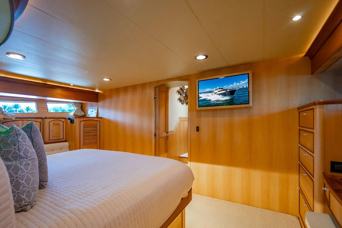a bedroom with a bed and a tv on the wall aboard NEVER BETTER Yacht for Sale