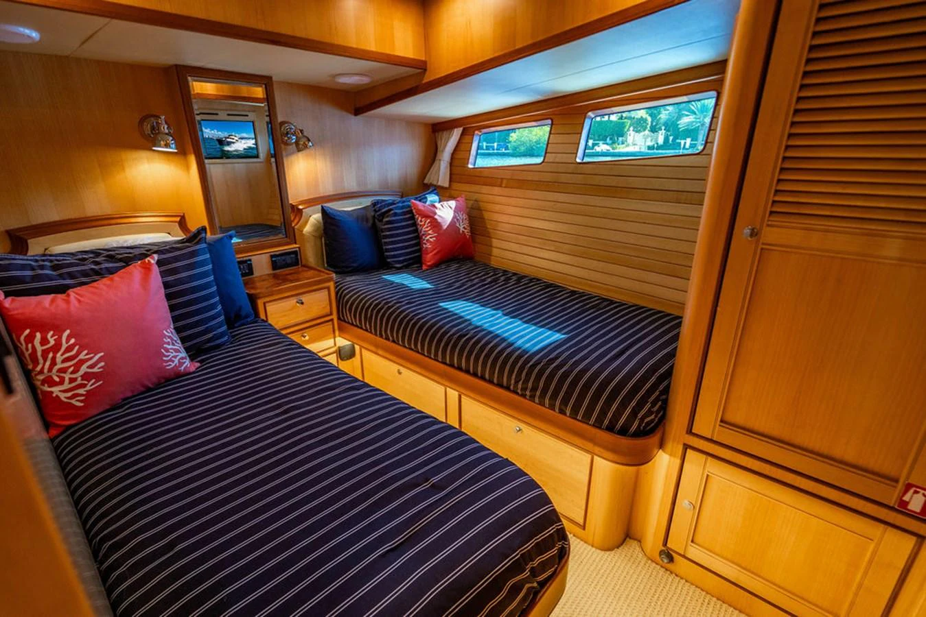 a bedroom with a bed and a dresser aboard NEVER BETTER Yacht for Sale