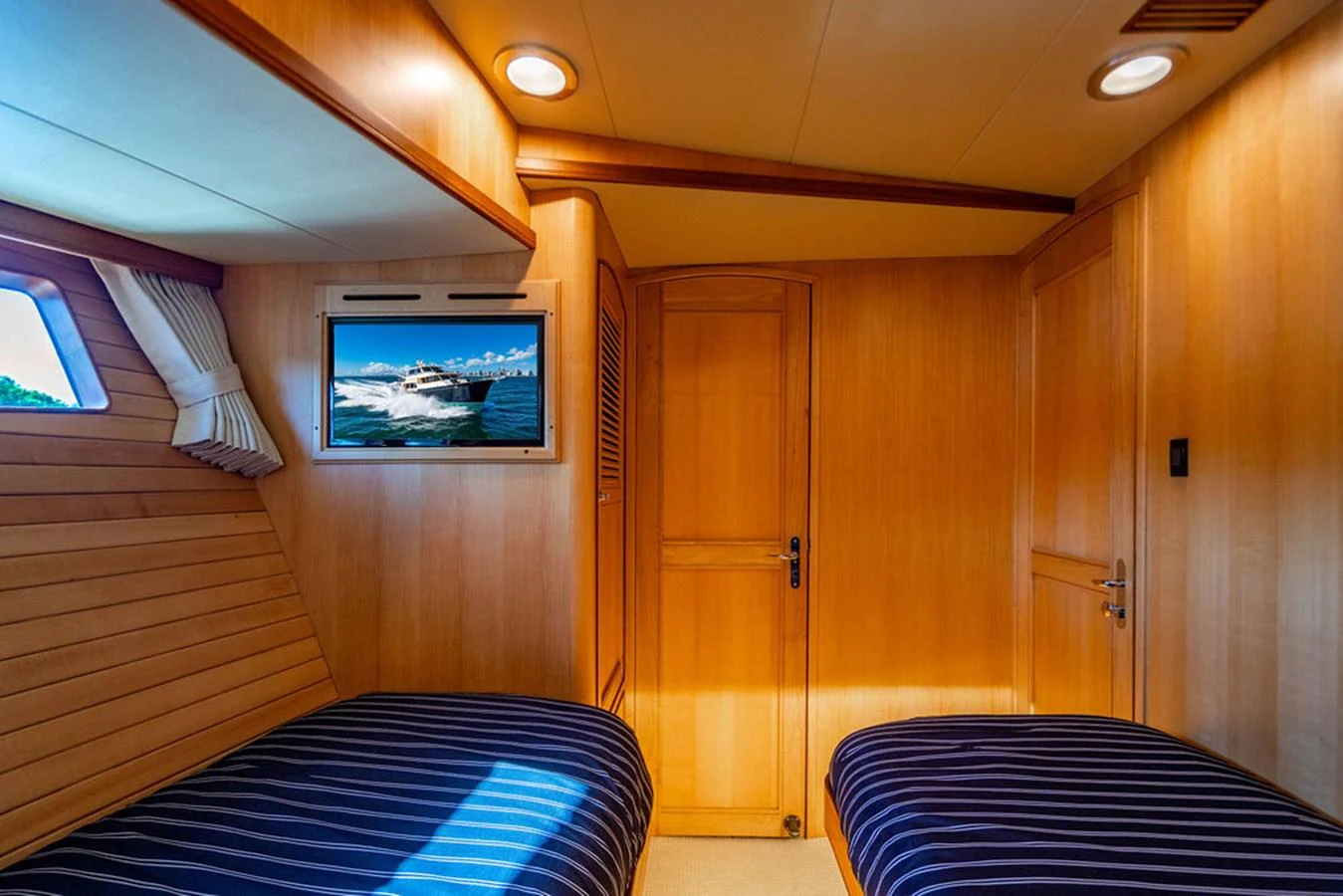 a room with a bed and a tv aboard NEVER BETTER Yacht for Sale