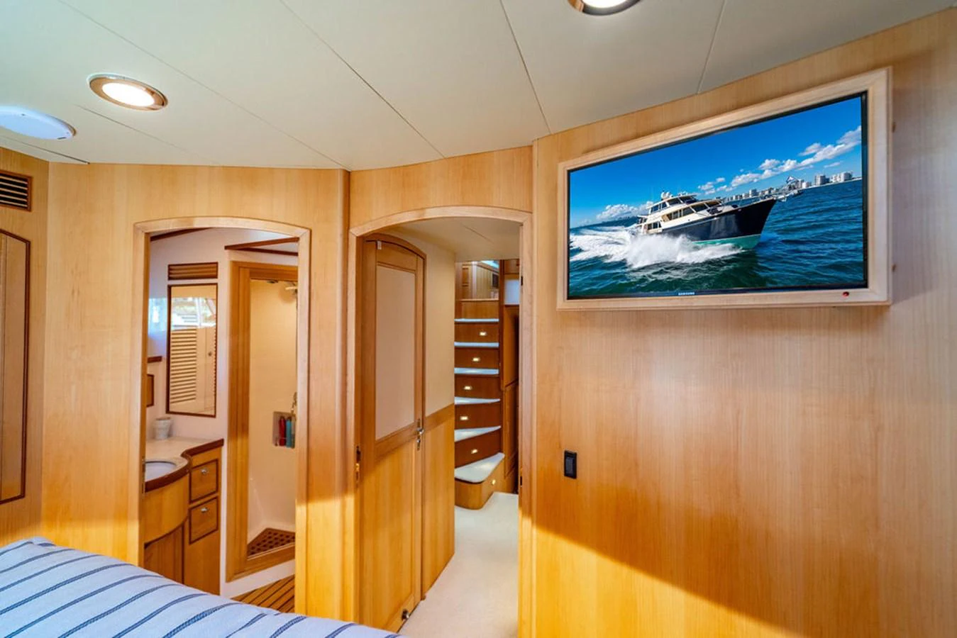 a room with a tv and a bed aboard NEVER BETTER Yacht for Sale