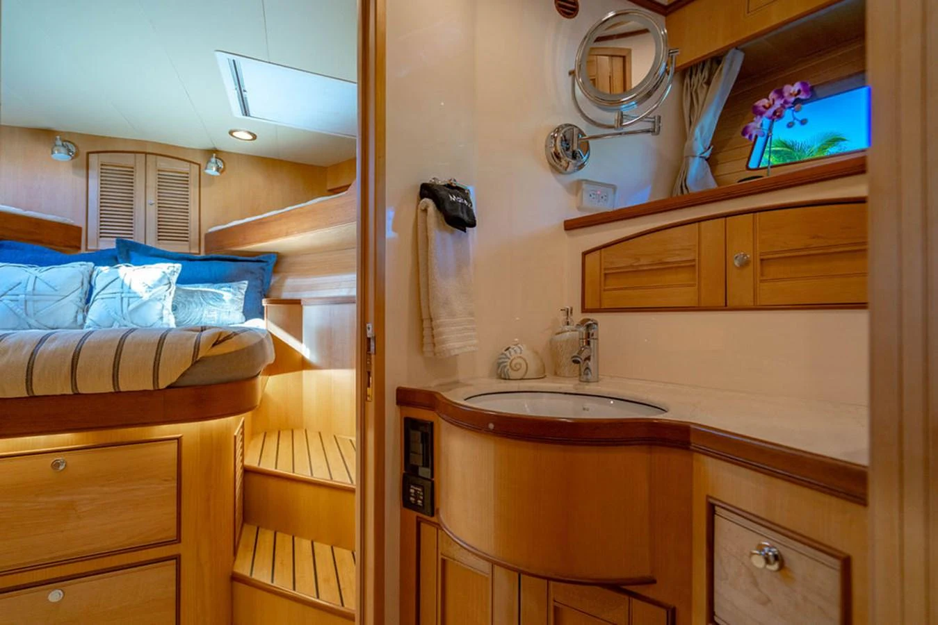 a bathroom with a sink and a bed aboard NEVER BETTER Yacht for Sale