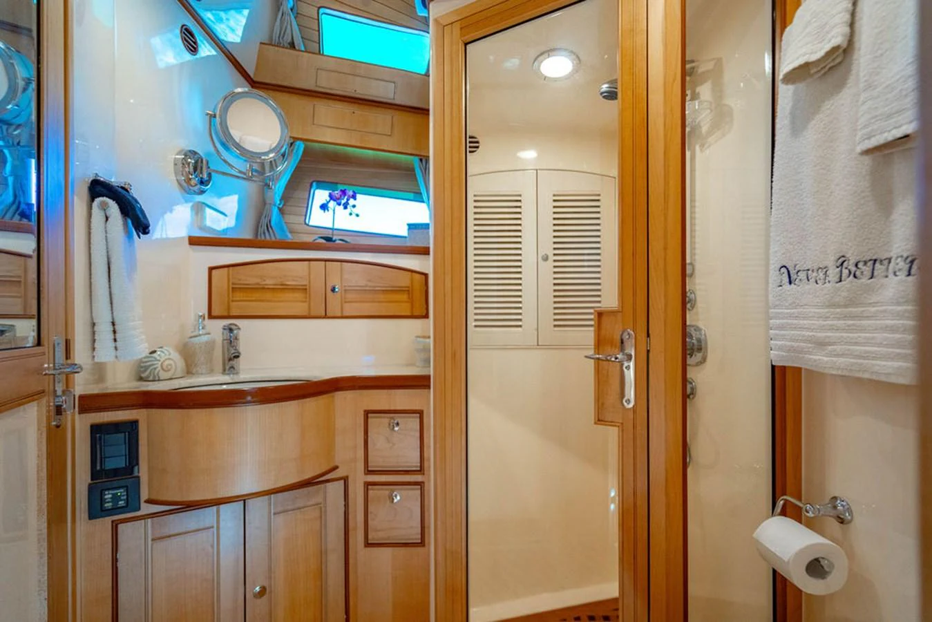 a bathroom with a sink and a tv aboard NEVER BETTER Yacht for Sale