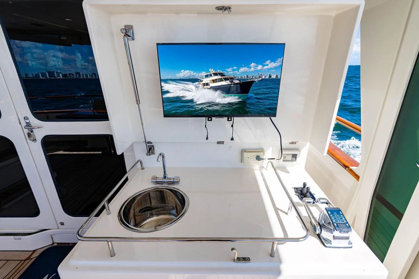 a white machine with a screen on the wall aboard NEVER BETTER Yacht for Sale