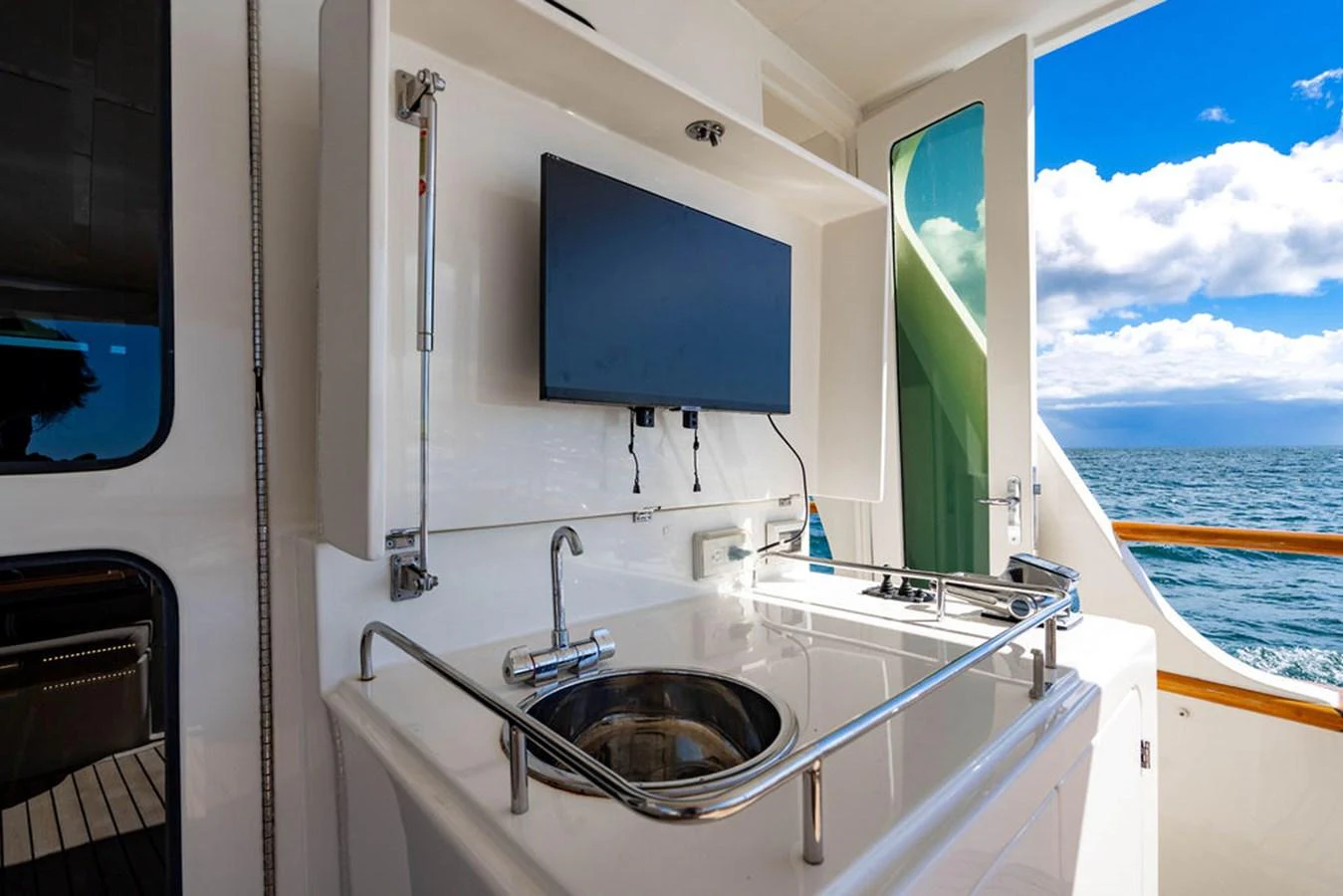 a boat with a sink and a screen on the side aboard NEVER BETTER Yacht for Sale