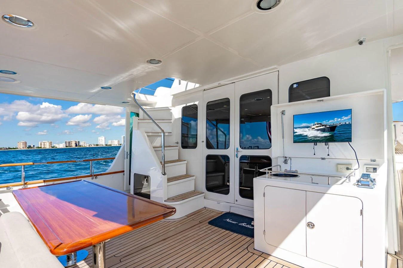 a room with a table and tv aboard NEVER BETTER Yacht for Sale