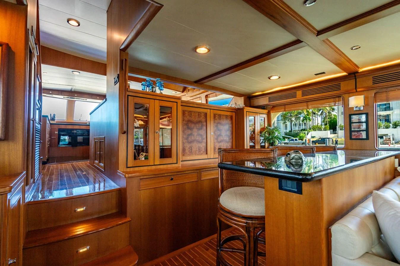 a kitchen with a bar and stools aboard NEVER BETTER Yacht for Sale