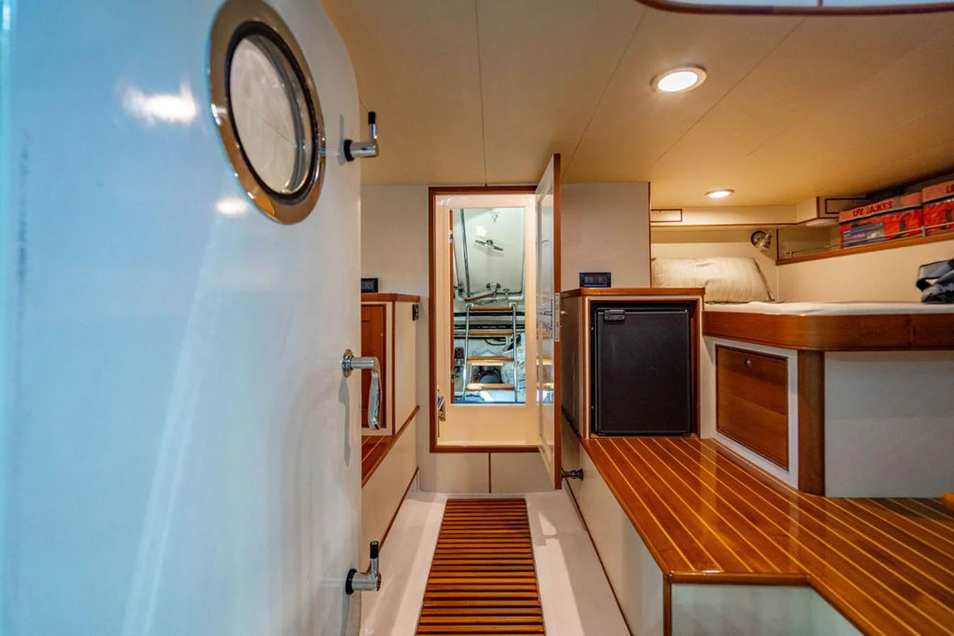 a room with a mirror and a wood floor aboard NEVER BETTER Yacht for Sale