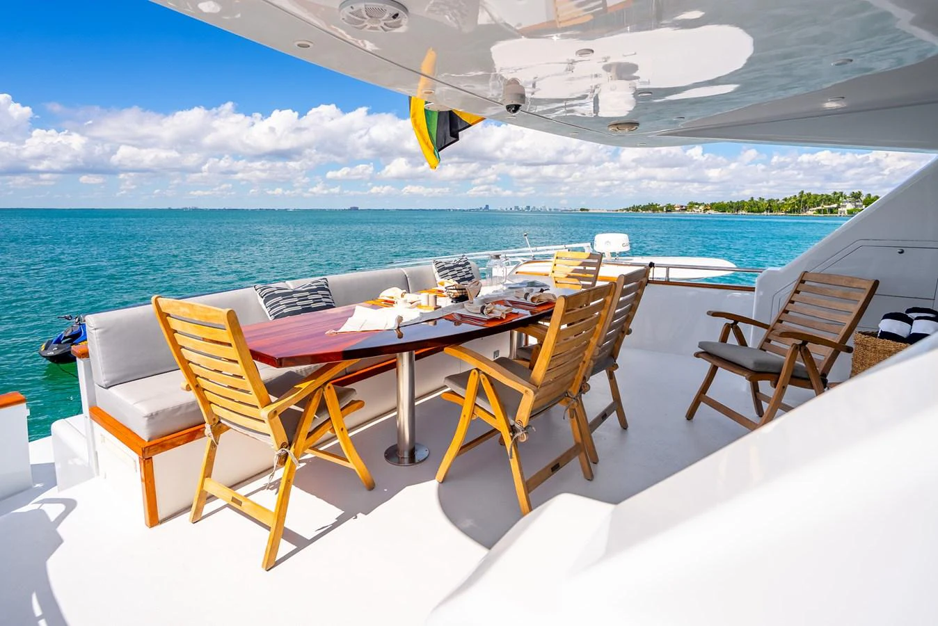a table and chairs on a beach aboard AZURE Yacht for Sale