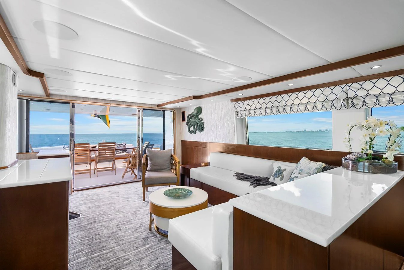 a room with a bed and chairs aboard AZURE Yacht for Sale
