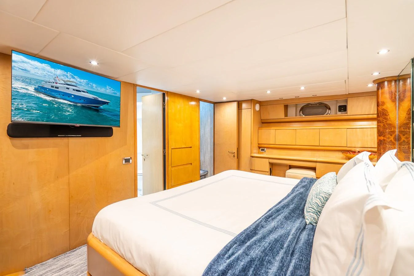 a room with a bed and a tv on the wall aboard AZURE Yacht for Sale
