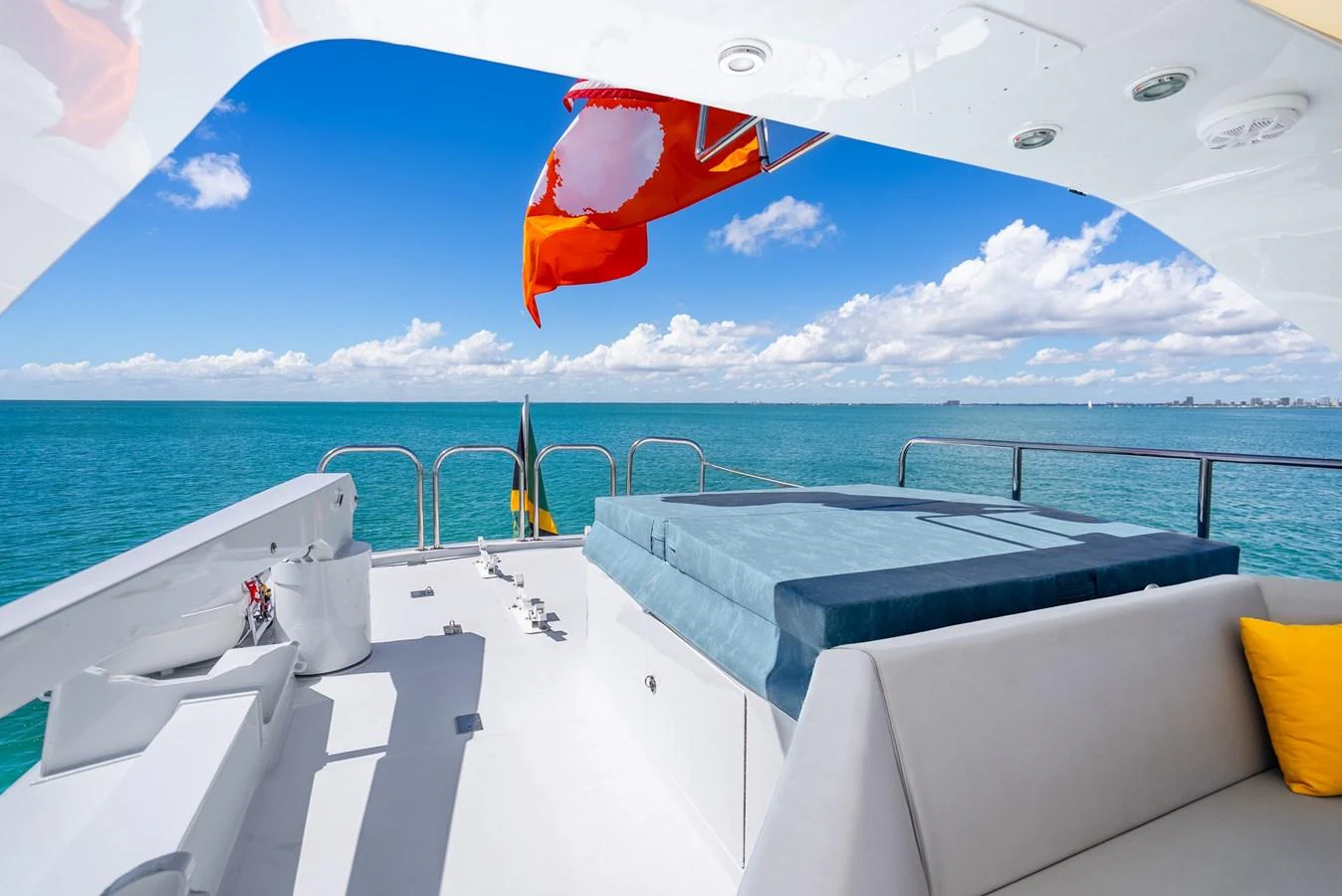 a deck with chairs and a flag aboard AZURE Yacht for Sale