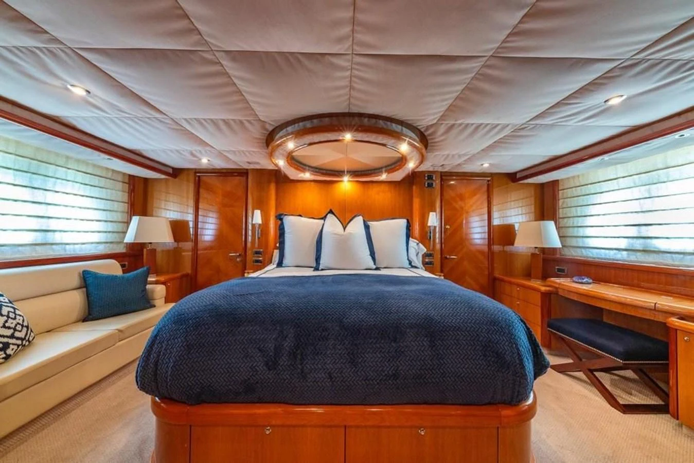 a bedroom with a large bed aboard ALAINA Yacht for Sale