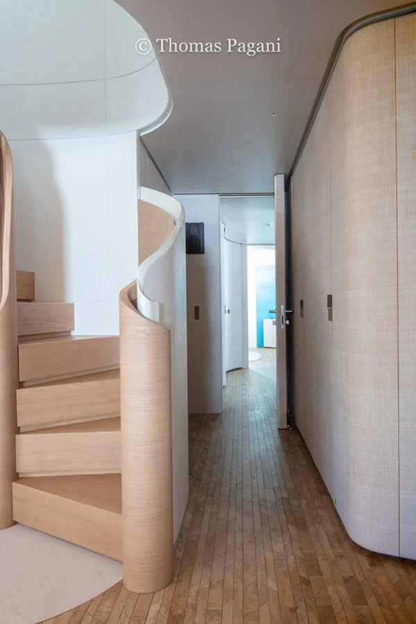 a hallway with a wood floor and white walls aboard MOUCHKA Yacht for Sale