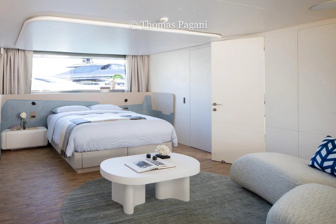 a bedroom with a bed and a table aboard MOUCHKA Yacht for Sale