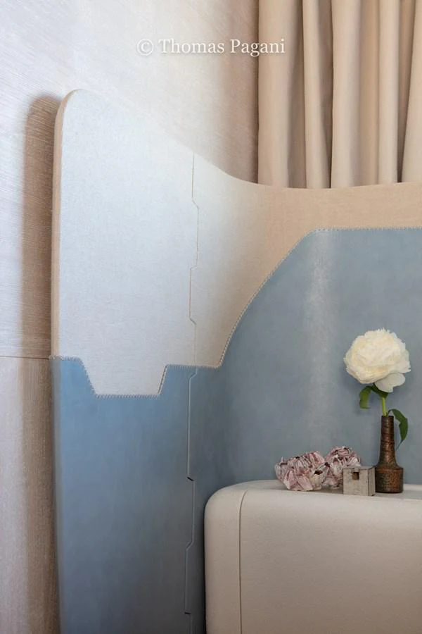 a room with a blue wall and curtains aboard MOUCHKA Yacht for Sale
