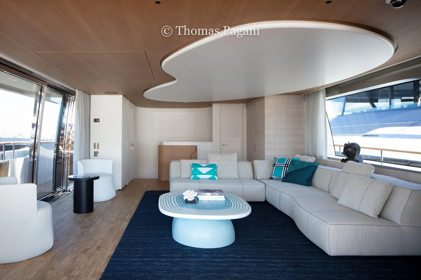 a living room with a large blue rug and white couches aboard MOUCHKA Yacht for Sale