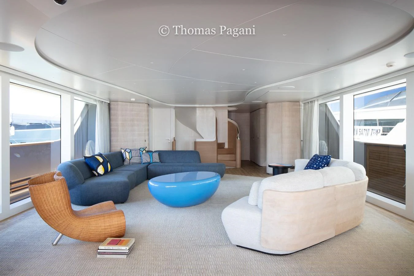 a living room with a blue couch aboard MOUCHKA Yacht for Sale