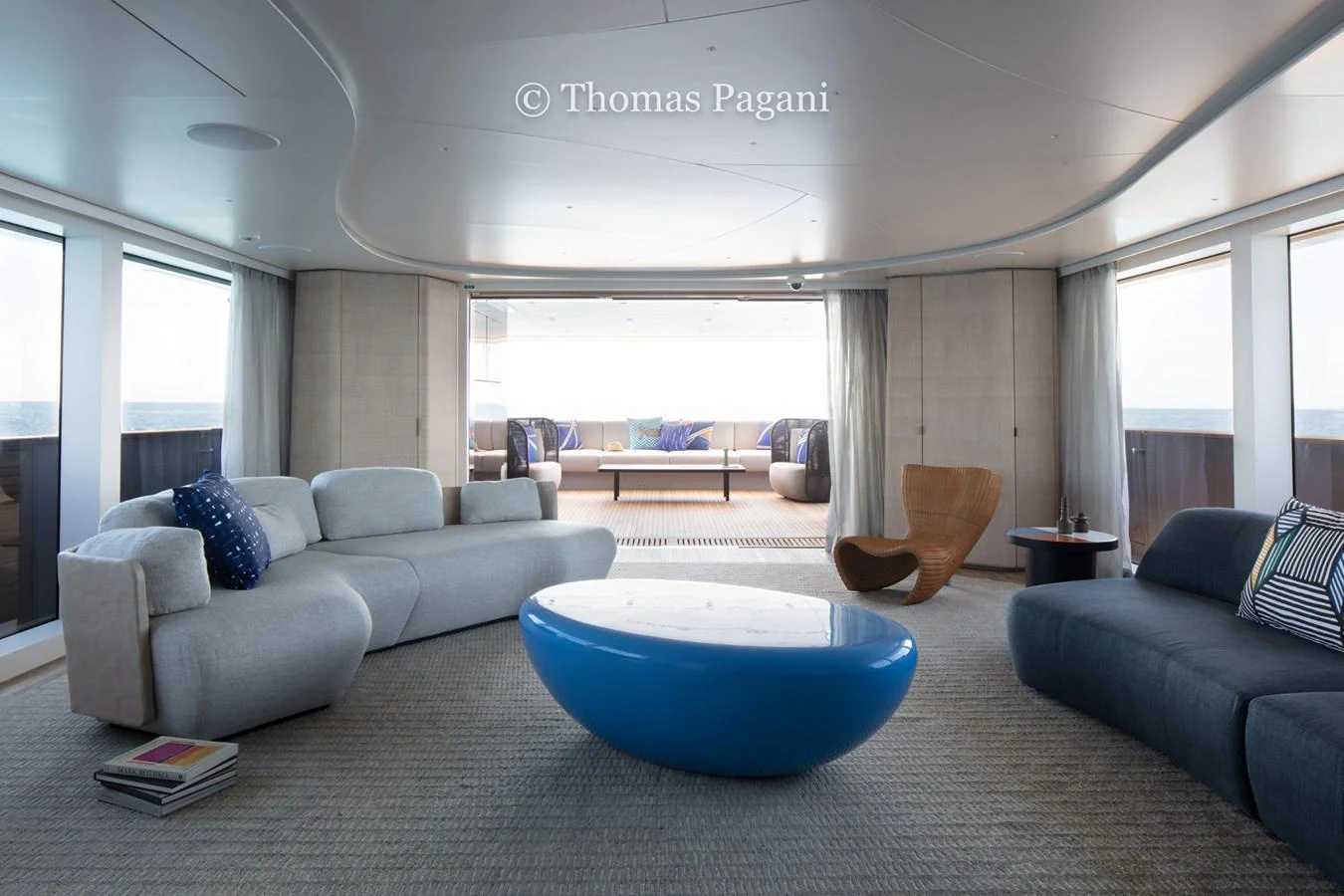 a living room with a blue couch aboard MOUCHKA Yacht for Sale