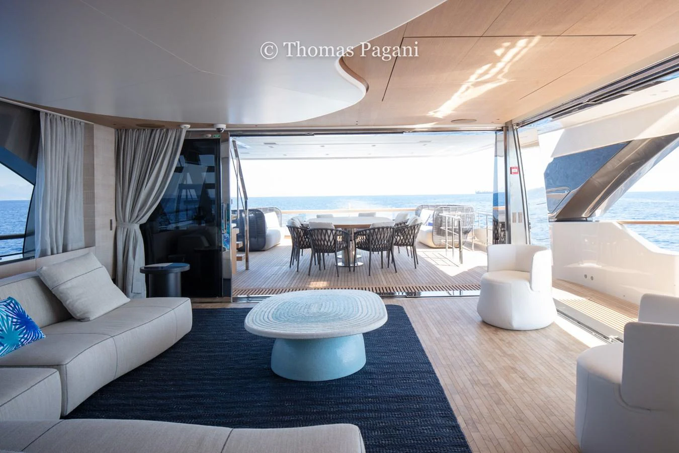 a room with a large window and a table with chairs and a large body of water aboard MOUCHKA Yacht for Sale