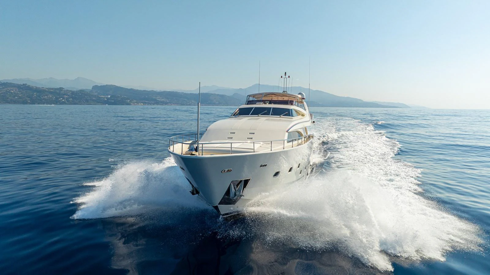 A luxurious yacht cruises through calm waters, showcasing its sleek design and powerful performance. aboard CHAMPAGNE AND CAVIAR Yacht for Sale