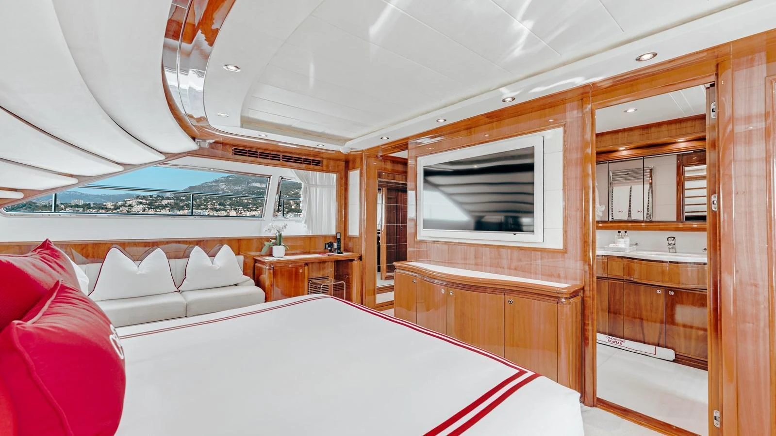 The master stateroom features elegant wood finishes, a large bed, and a spacious ensuite bathroom. aboard CHAMPAGNE AND CAVIAR Yacht for Sale