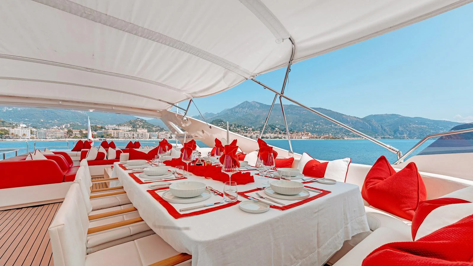 An elegant alfresco dining area with a stunning view of the coastline. aboard CHAMPAGNE AND CAVIAR Yacht for Sale