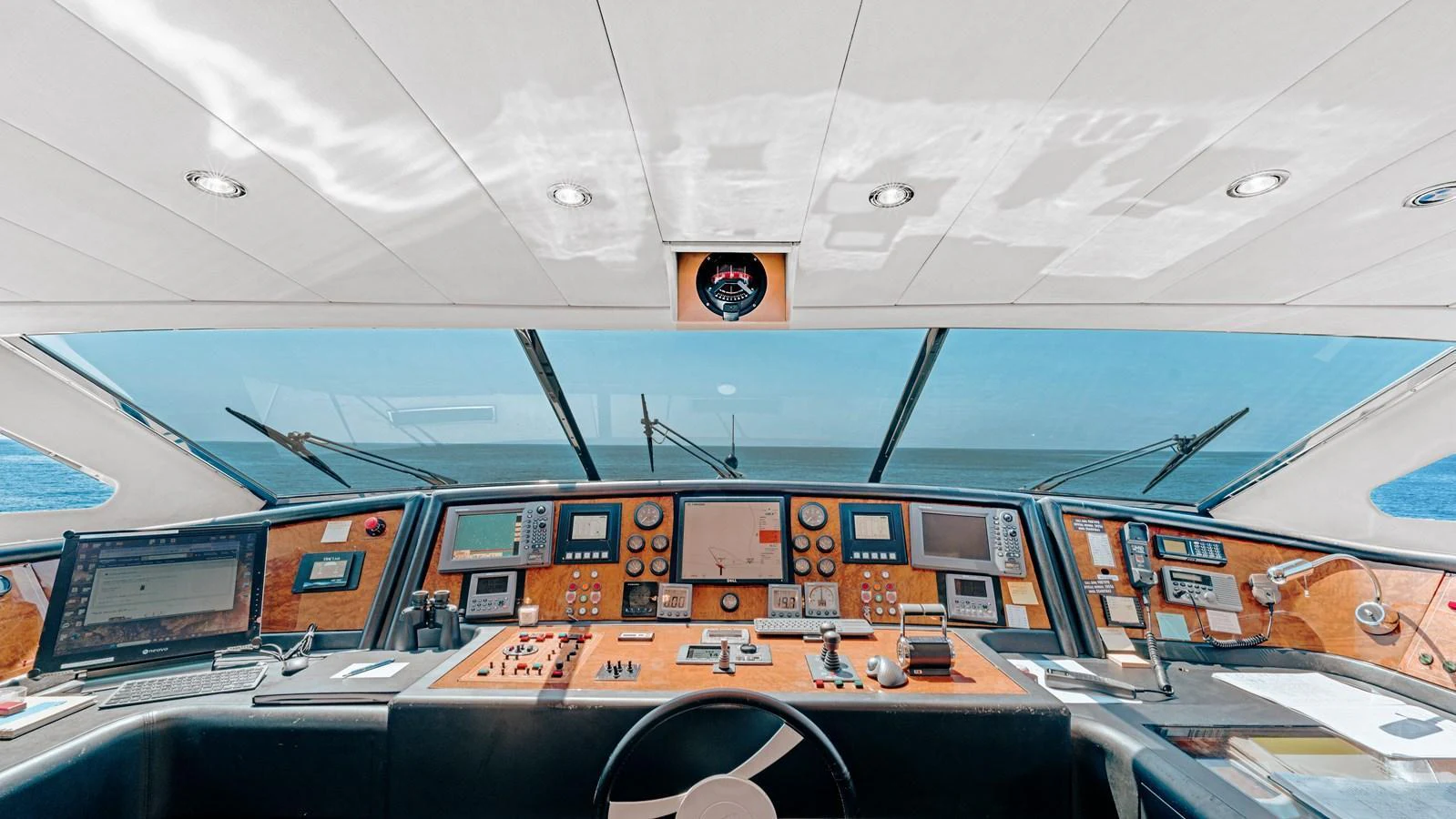 The helm station offers a panoramic view with advanced navigation equipment and luxurious finishes. aboard CHAMPAGNE AND CAVIAR Yacht for Sale
