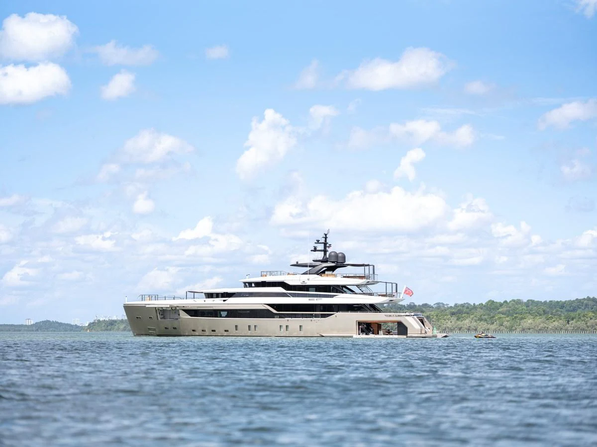 A sleek and modern yacht cruises gracefully on calm waters under a clear blue sky. aboard ANNABELLA Yacht for Sale