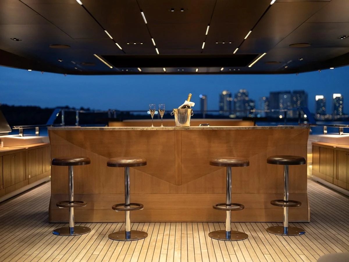 The yacht features a stylish bar area with modern stools and a champagne setup, perfect for evening entertainment. aboard ANNABELLA Yacht for Sale