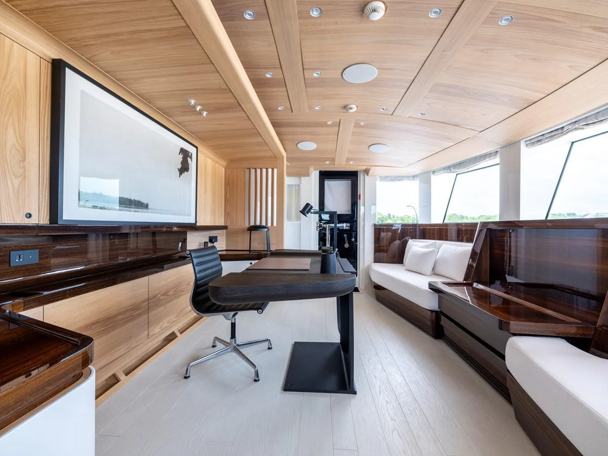 The yacht's office features modern furnishings with ample natural light and elegant wood finishes. aboard ANNABELLA Yacht for Sale