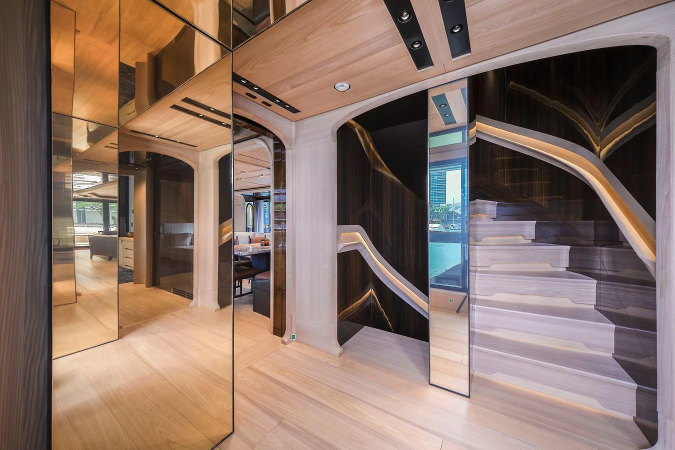 The yacht's interior features a modern design with sleek wooden finishes and mirrored accents. aboard ANNABELLA Yacht for Sale