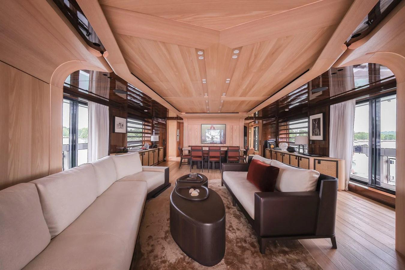 The yacht's salon features elegant wood paneling, plush seating, and large windows for natural light. aboard ANNABELLA Yacht for Sale