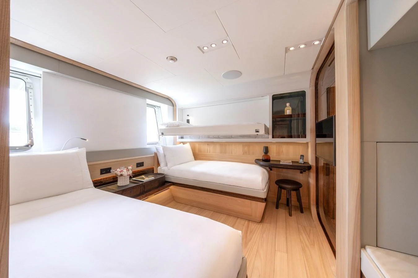 A serene guest cabin featuring twin beds and modern wooden furnishings. aboard ANNABELLA Yacht for Sale
