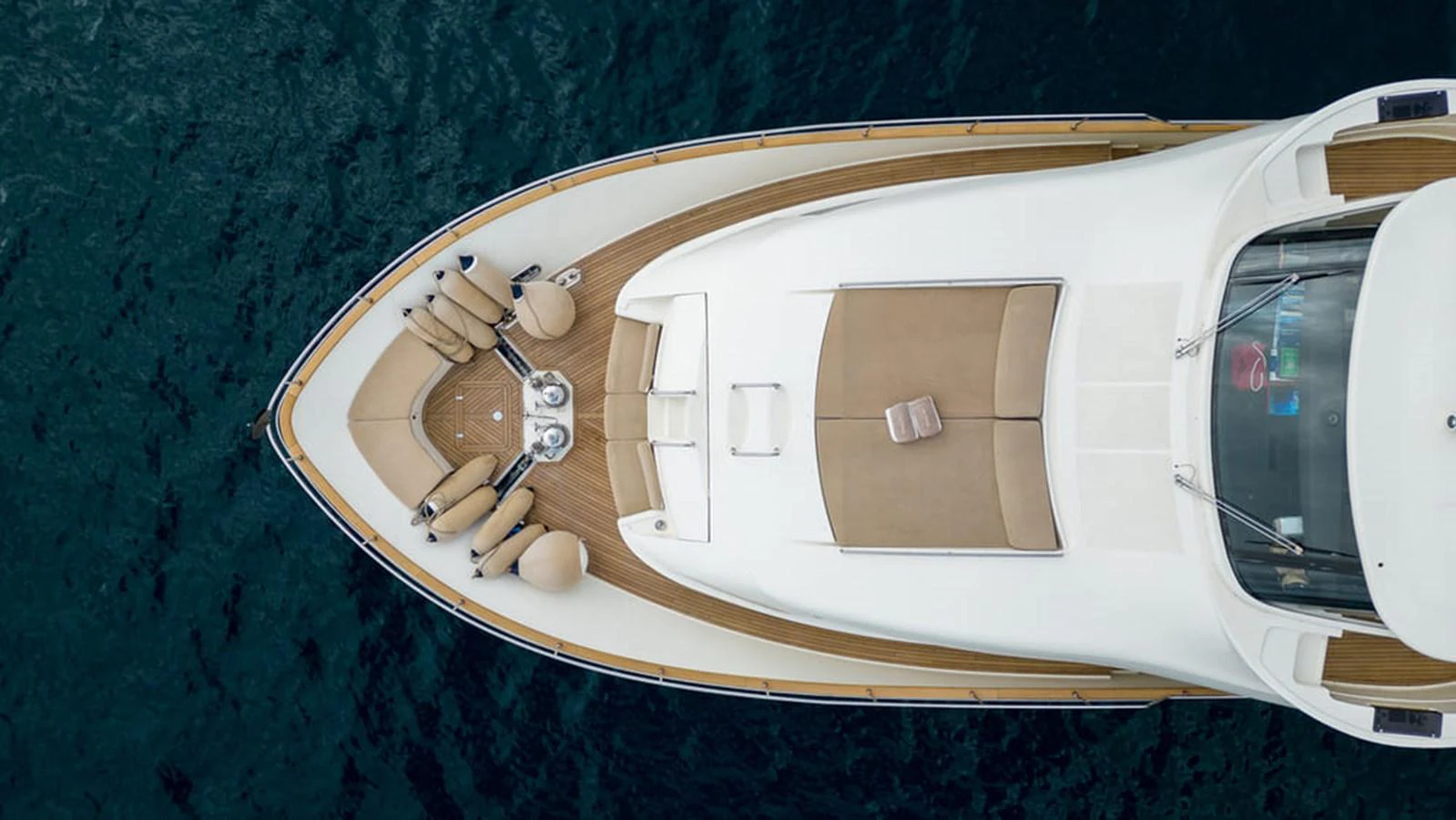a white boat on a body of water aboard LA PAUSA Yacht for Sale