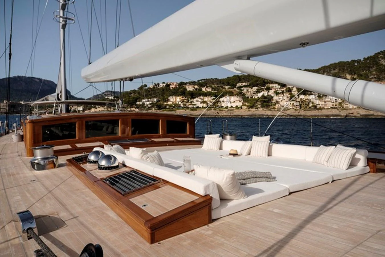 The yacht's deck features a spacious lounging area with plush cushions and a sleek design. aboard APSARA Yacht for Sale