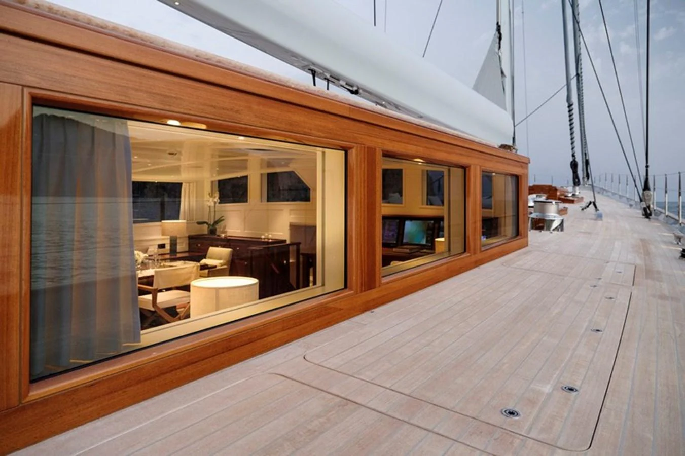 The yacht's deck features large windows offering a glimpse into the luxurious interior. aboard APSARA Yacht for Sale