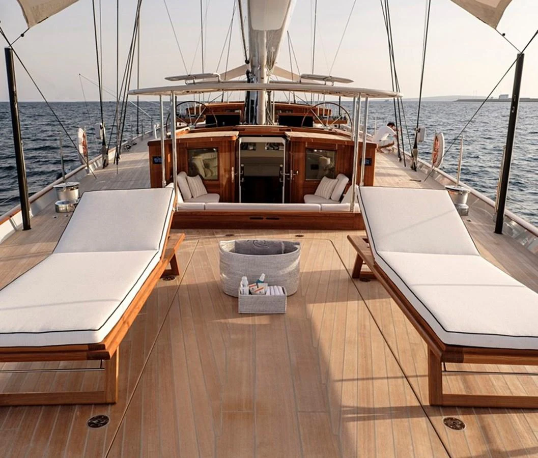 The yacht's deck features luxurious sun loungers and a spacious, elegant layout perfect for relaxation. aboard APSARA Yacht for Sale