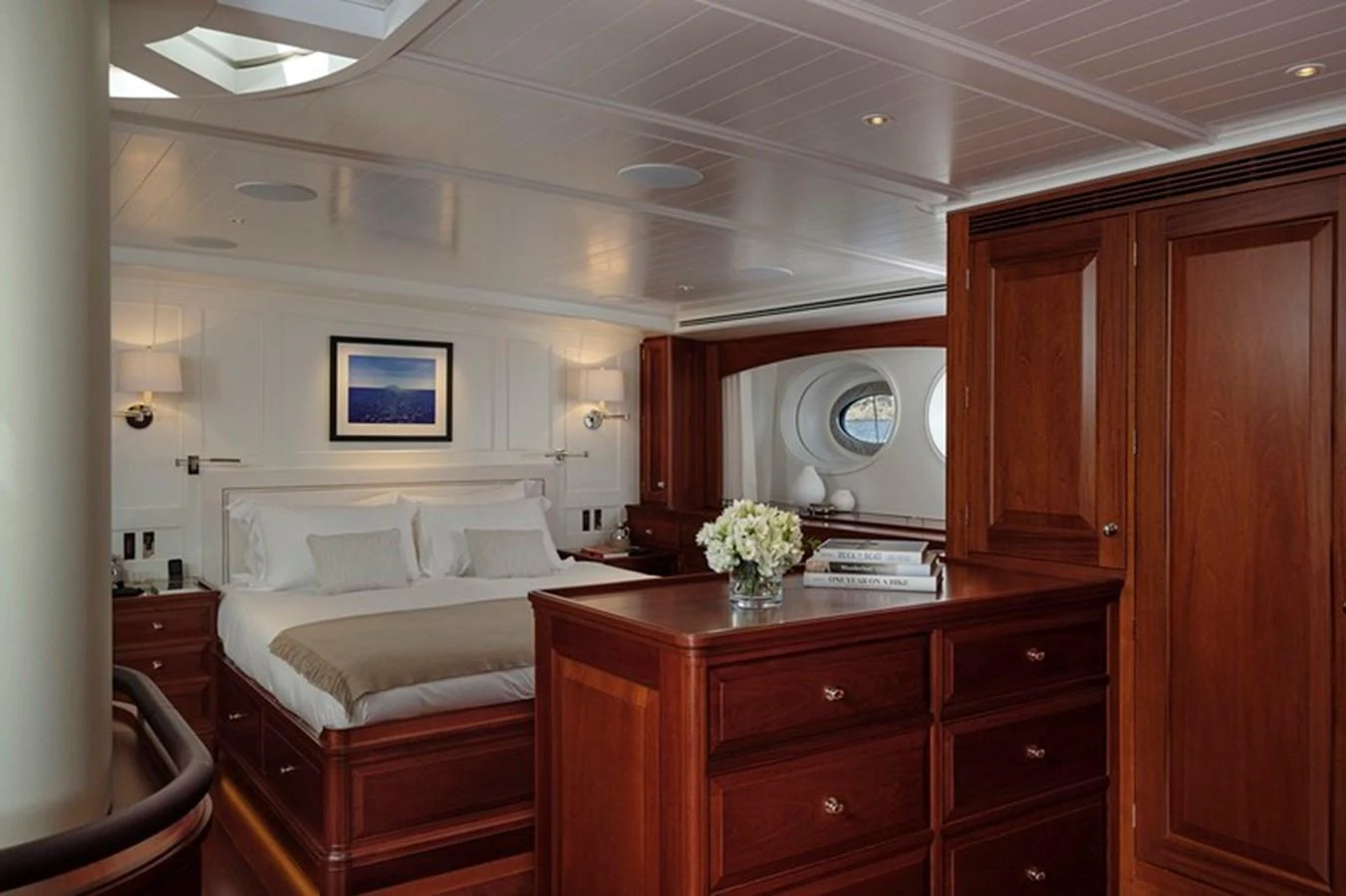 The master stateroom features elegant wood finishes and a luxurious bed, creating a serene and inviting atmosphere. aboard APSARA Yacht for Sale
