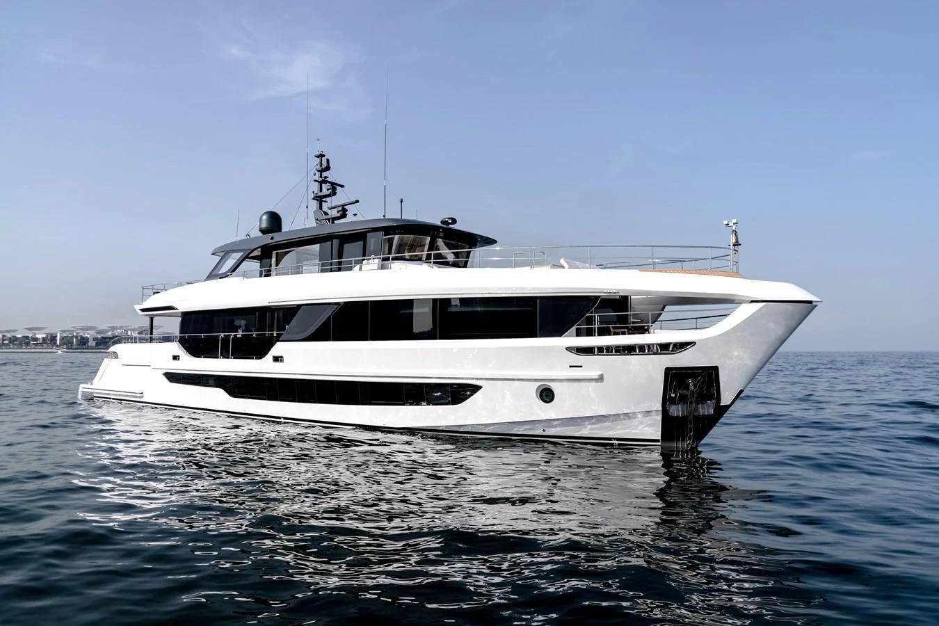 A sleek and modern yacht glides gracefully on calm waters under a clear sky. aboard 100 TERRACE ON-ORDER Yacht for Sale