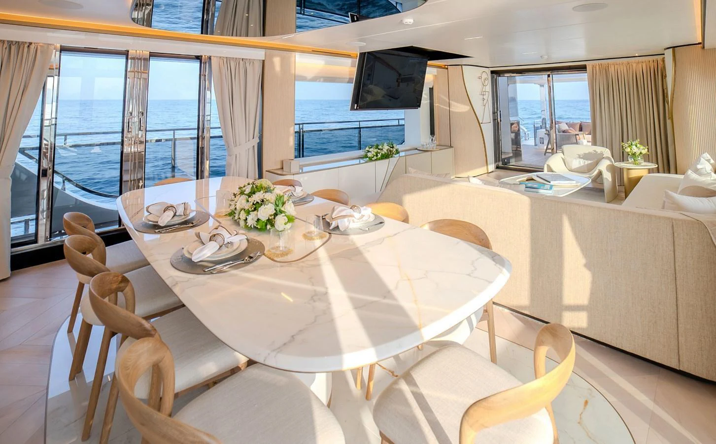 The yacht's dining area features elegant seating and a stunning ocean view. aboard 100 TERRACE ON-ORDER Yacht for Sale