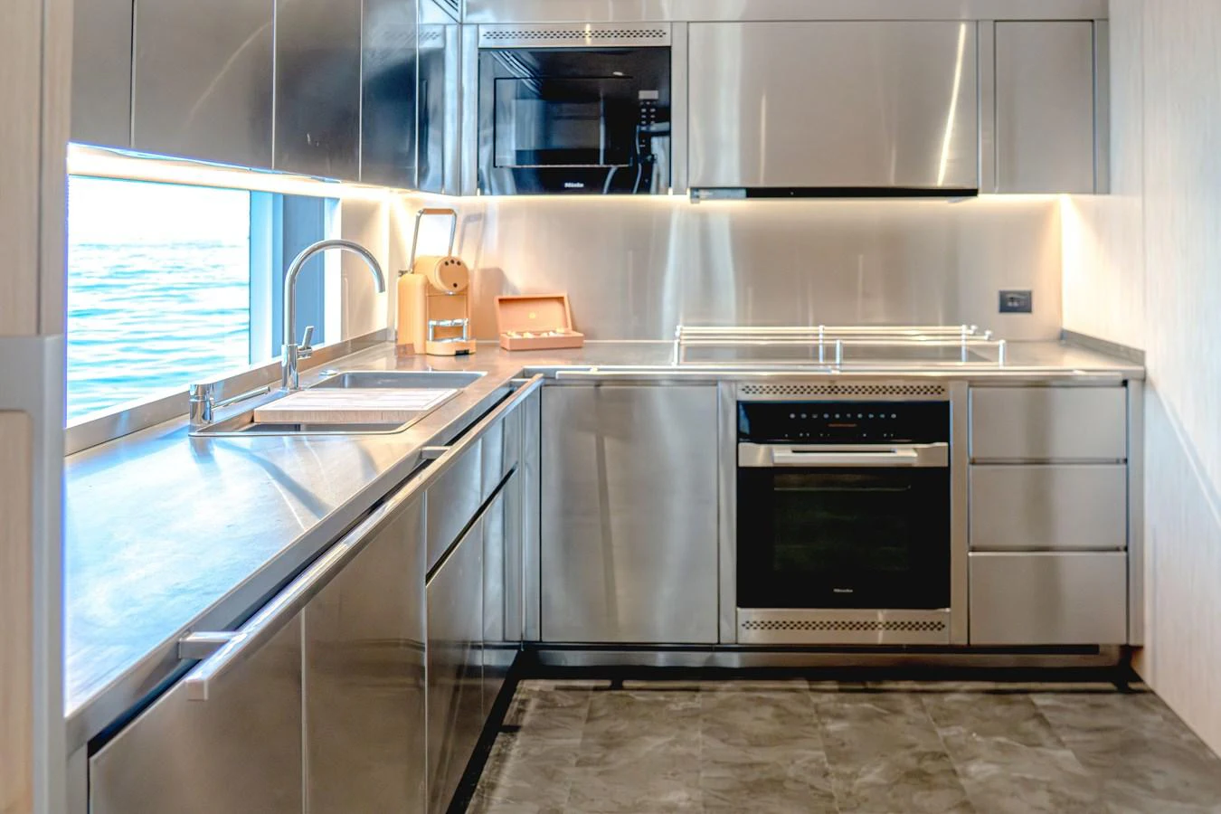 The yacht's galley features sleek stainless steel appliances and modern cabinetry, creating a sophisticated and functional space. aboard 100 TERRACE ON-ORDER Yacht for Sale