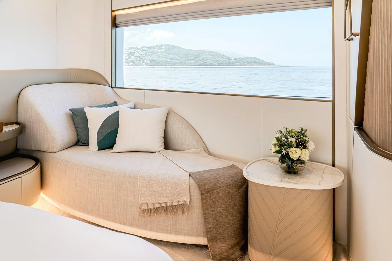A serene stateroom with a cozy lounge area and a picturesque sea view. aboard 100 TERRACE ON-ORDER Yacht for Sale
