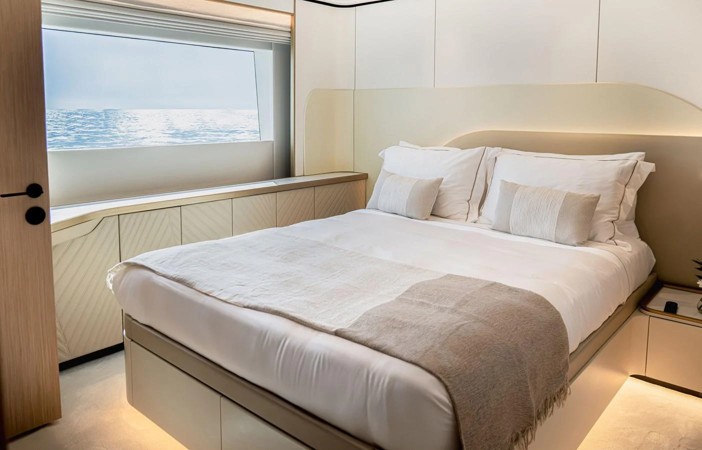A luxurious stateroom with a large bed and a scenic ocean view through the window. aboard 100 TERRACE ON-ORDER Yacht for Sale