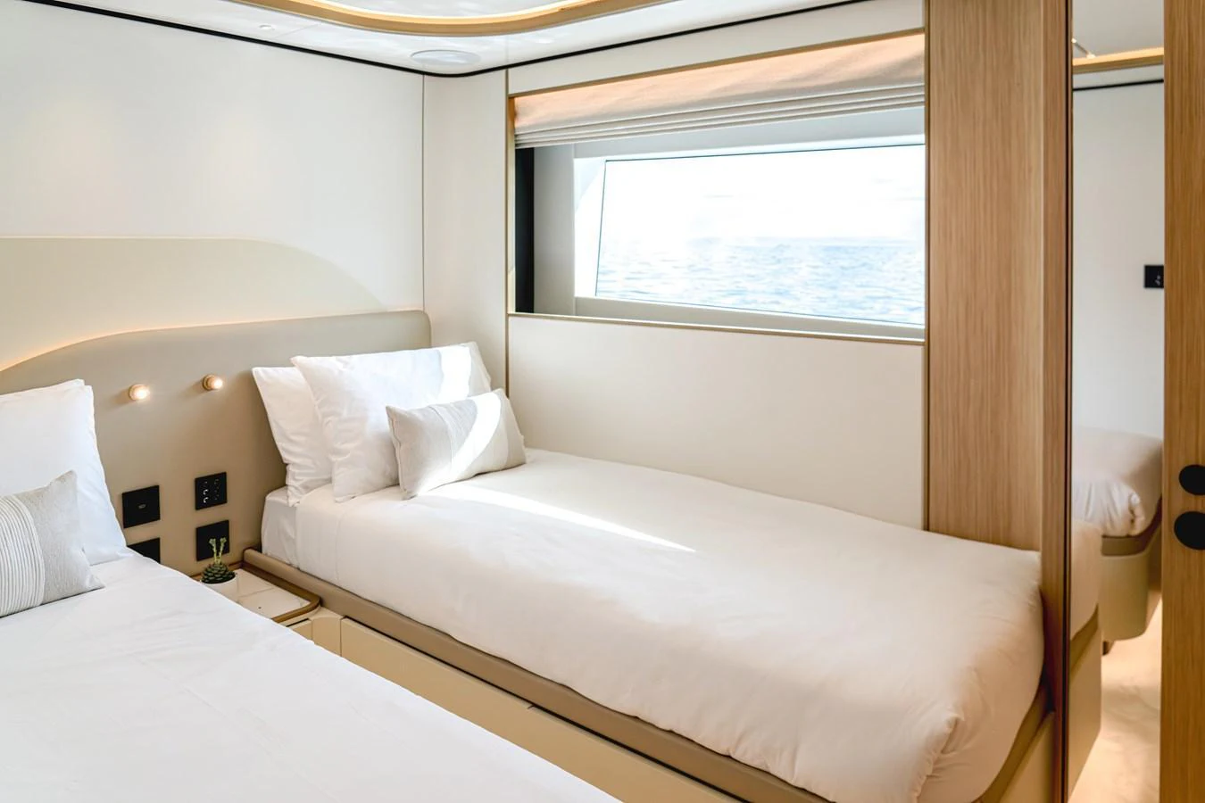 The guest stateroom features twin beds and a large window offering a serene ocean view. aboard 100 TERRACE ON-ORDER Yacht for Sale