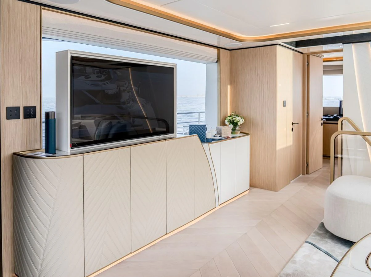 The yacht's interior features a modern entertainment area with a large TV and elegant cabinetry. aboard 100 TERRACE ON-ORDER Yacht for Sale