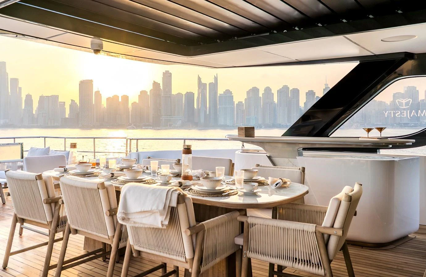 The aft deck offers a luxurious dining area with a stunning city skyline view. aboard 100 TERRACE ON-ORDER Yacht for Sale